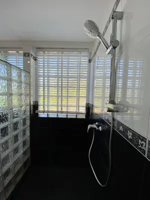 a bathroom with a shower with a shower head at Andaman Hills pool Seaview house in Patong Beach