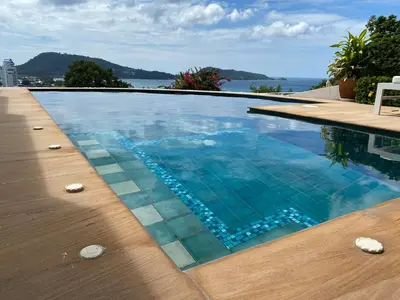 a swimming pool with a view of the water at Andaman Hills pool Seaview house in Patong Beach