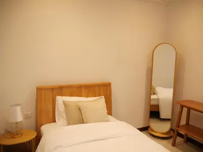 a bedroom with a bed and a mirror at Bernard Travel in Phuket Town