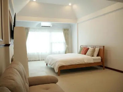 a bedroom with a bed and a window at Bernard Travel in Phuket Town