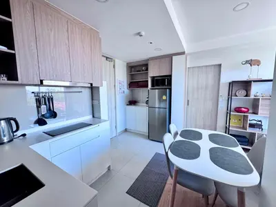 a kitchen with a table and chairs in a room at Laguna Skypark 2 Bedroom scenic view in Laguna Phuket