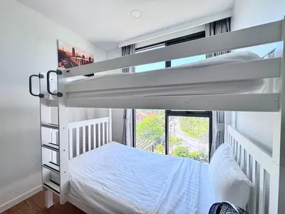 a bedroom with two bunk beds and a window at Laguna Skypark 2 Bedroom scenic view in Laguna Phuket