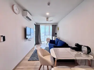 a living room with a blue couch and a table at Skypark New Building 4th floor Mountain View in Laguna Phuket