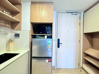 a kitchen with a refrigerator and a microwave at Skypark New Building 4th floor Mountain View in Laguna Phuket