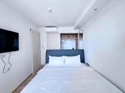 a bedroom with a bed and a flat screen tv at Skypark New Building 4th floor Mountain View in Laguna Phuket