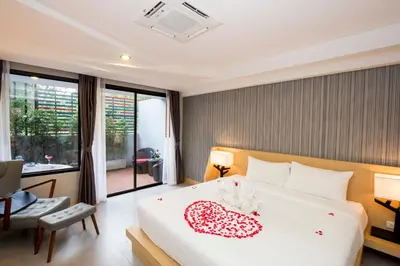 a bedroom with a bed with a heart on it at Apple A Day Resort Krabi, Ao Nang Beach in Ao Nang Beach