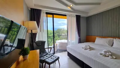 a bedroom with a bed and a tub and a balcony at Apple A Day Resort Krabi, Ao Nang Beach in Ao Nang Beach
