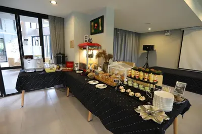 a long table with food on it in a room at Apple A Day Resort Krabi, Ao Nang Beach in Ao Nang Beach