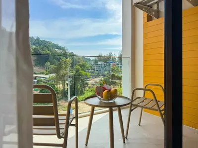a table and chairs on a balcony with a view at Great Apartment Sea Heaven 2 min to Nai Thon Beach in Nai Thon Beach