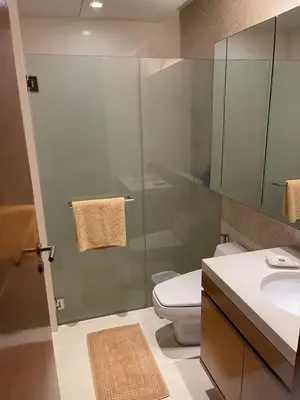 a bathroom with a shower and a toilet and a sink at Beachfront 2BR Apartment with Pool View in Nai Thon Beach