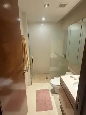 a bathroom with a toilet and a sink and a shower at Beachfront 2BR Apartment with Pool View in Nai Thon Beach