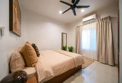 a bedroom with a bed and a ceiling fan at Greenleaf Estate - Gated Villas with large shared pool, Nai harn beach in Rawai Beach