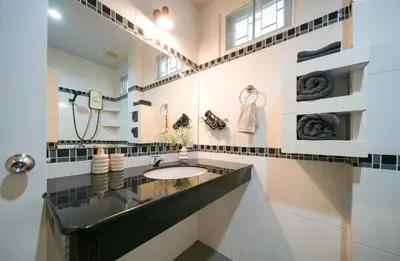 a bathroom with a sink and a mirror at Greenleaf Estate - Gated Villas with large shared pool, Nai harn beach in Rawai Beach