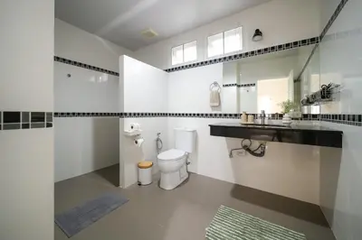 a white bathroom with a toilet and a sink at Greenleaf Estate - Gated Villas with large shared pool, Nai harn beach in Rawai Beach