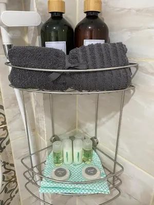 a rack with three bottles of water and towels at Guest Room Bang Tao MMA in Ban Thalat Choeng Thale