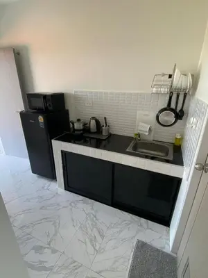 a kitchen with a sink and a counter top at Guest Room Bang Tao MMA in Ban Thalat Choeng Thale