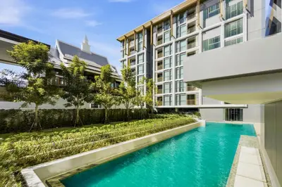 a swimming pool in front of a building at The Ozone Bangtao by Beringela in Laguna Phuket