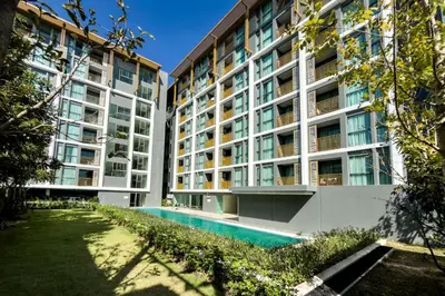 an apartment building with a swimming pool in front of it at The Ozone Bangtao by Beringela in Laguna Phuket