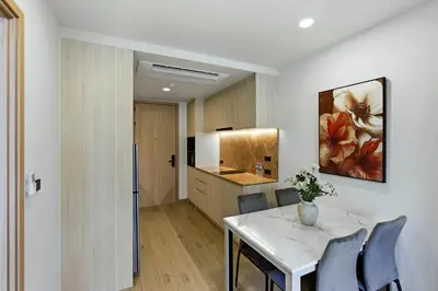 a kitchen and dining room with a table and chairs at The Ozone Bangtao by Beringela in Laguna Phuket