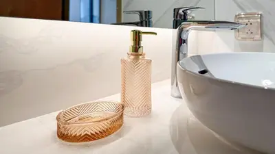 a bathroom counter with a bottle and a sink at The AQUA A202 in Bang Tao Beach