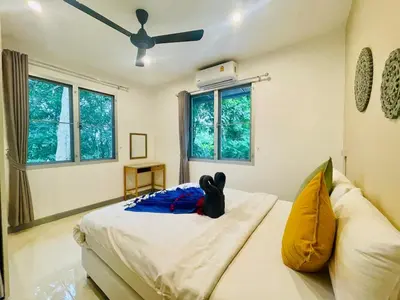a bedroom with a bed and a ceiling fan at Private single house Kata Beach in Kata Beach