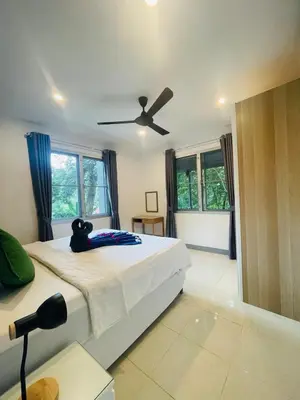 a bedroom with a bed and a ceiling fan at Private single house Kata Beach in Kata Beach