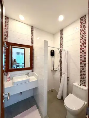 a bathroom with a toilet and a sink and a mirror at Cozy Thai-Style House with Private Pool, Bang Tao in Ban Pak Lak