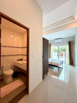 a bathroom with a toilet and a sink and a bed at Cozy Thai-Style House with Private Pool, Bang Tao in Ban Pak Lak