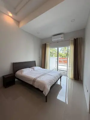 a bedroom with a bed and a large window at Cozy Thai-Style House with Private Pool, Bang Tao in Ban Pak Lak