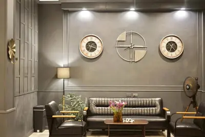 a living room with a couch and clocks on the wall at The Sense 2 in Patong Beach