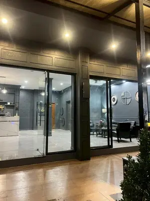 a room with glass doors and a living room at The Sense 2 in Patong Beach