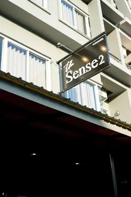 a sign on the side of a building at The Sense 2 in Patong Beach