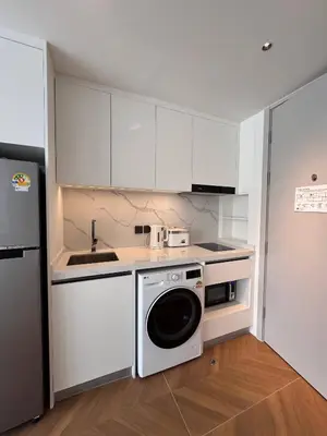 a kitchen with white cabinets and a dishwasher at Studio Apartment by Sunshine Beach in Layan Beach