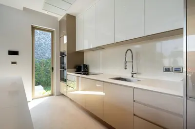 a kitchen with white cabinets and a sink at NEW Luxury 4BR Villa with Pool & relaxation zones D07 in Phuket