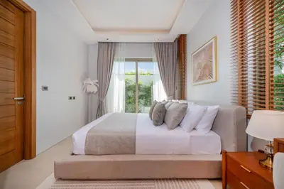 a bedroom with a large bed and a window at NEW Luxury 4BR Villa with Pool & relaxation zones D07 in Phuket