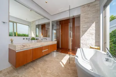 a bathroom with a tub and a large window at NEW Luxury 4BR Villa with Pool & relaxation zones D07 in Phuket