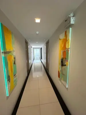 a hallway with colorful paintings on the walls at 2 комнатные апартаменты с одной спальней и кухней-гостиной in Phuket Town