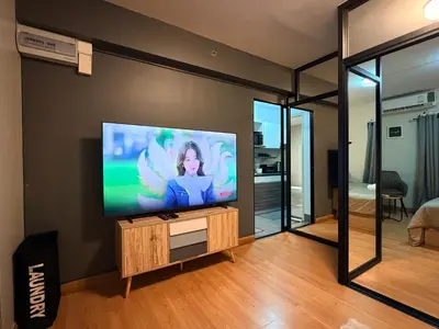 a living room with a flat screen tv on a wall at 1BR Apartment Suite in the heart of Phuket Town in Ban Lo Long