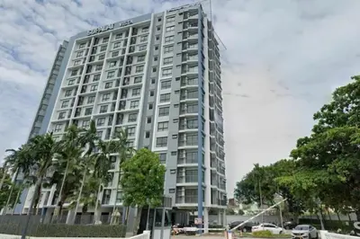 a tall white building with palm trees in front of it at 1BR Apartment Suite in the heart of Phuket Town in Ban Lo Long