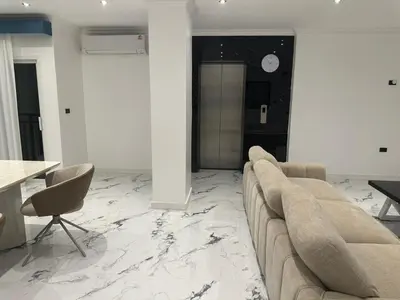 a living room with a couch and a table at Elite Luxury Apartment Patong in Patong Beach