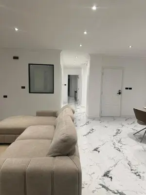 a living room with a couch and a flat screen tv at Elite Luxury Apartment Patong in Patong Beach