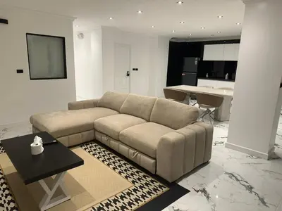 a living room with a couch and a table at Elite Luxury Apartment Patong in Patong Beach
