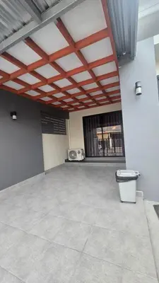 a large empty room with a table and a microwave at Phuket villa airport in Nai Yang Beach