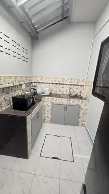 a kitchen with a counter and a tile floor at Phuket villa airport in Nai Yang Beach