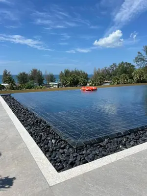 a pool of water with rocks around it at Laguna Beach Residences Seashore by Banyan Living in Phuket
