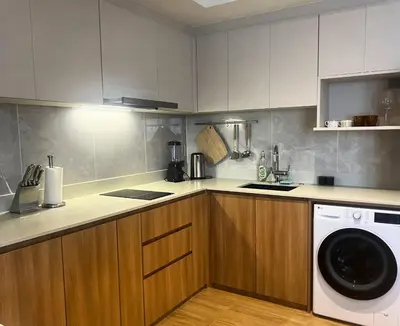 a kitchen with a washer and a washing machine at Laguna Beach Residences Seashore by Banyan Living in Phuket