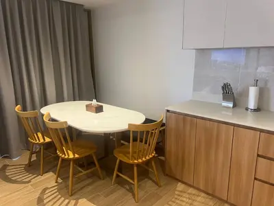 a kitchen with a table and chairs and a counter at Laguna Beach Residences Seashore by Banyan Living in Phuket