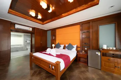 a bedroom with a large bed and a bathroom at D Villa Phuket-Luxury 6-Bedroom Private Villa in Panwa Entire Place in Phuket Town