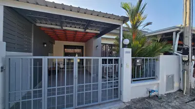 a house with a gate and a fence at Joyful House Naiyang beach in Thalang