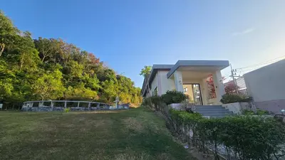 a house with a yard in front of it at Joyful House Naiyang beach in Thalang